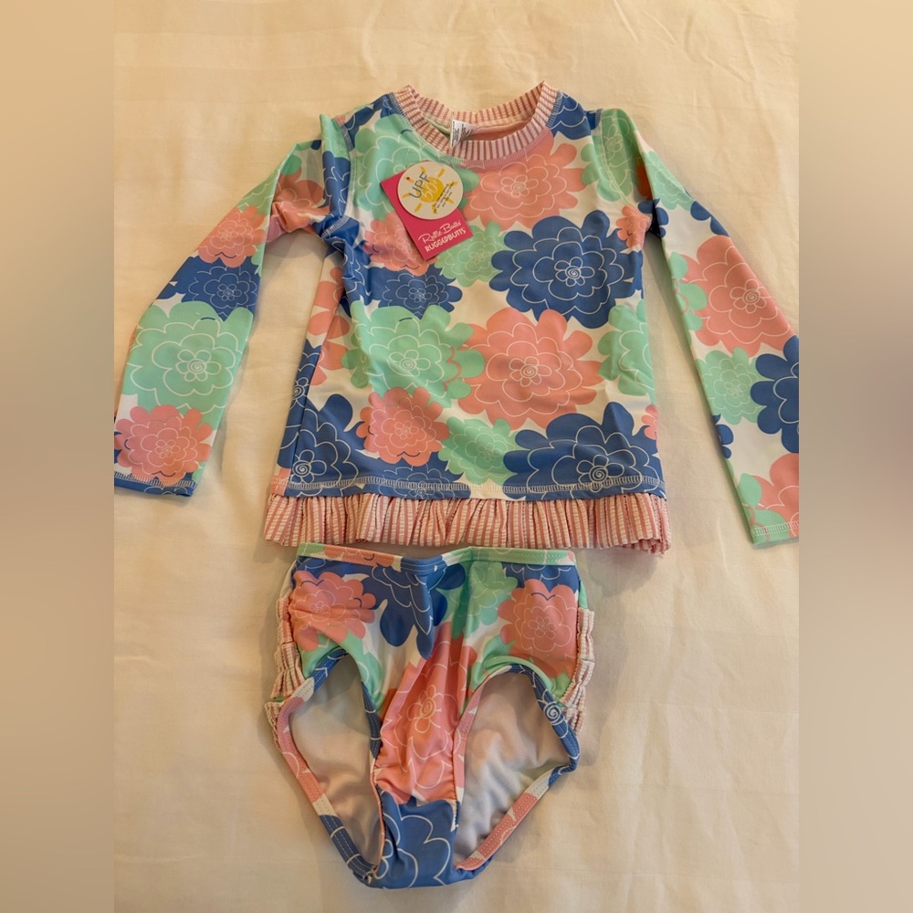 NWT Ruffle Butts long sleeve rash guard. Size 7. Pastel petals color. 2 piece.